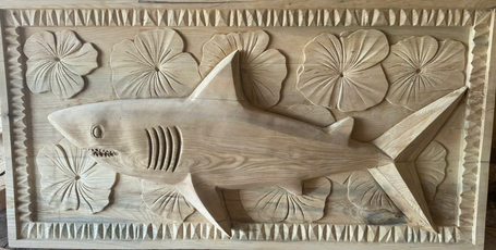 Hand-carved shark and hibiscus wall panel in ash, raw carving before finishing