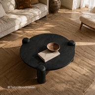 Round coffee table with dark wood finish and clean minimalist design