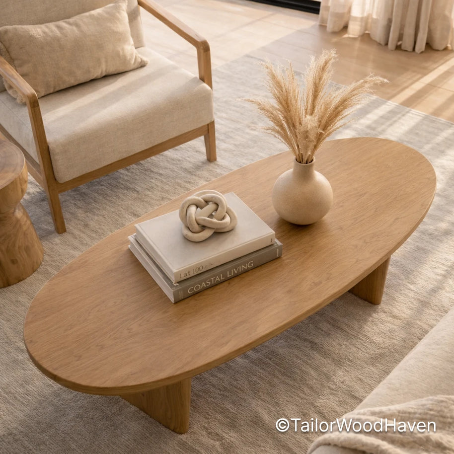 Light wood oval coffee table with smooth surface and minimalist design
