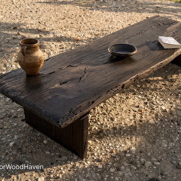 Black outdoor coffee table made of solid wood with a smooth surface and modern design