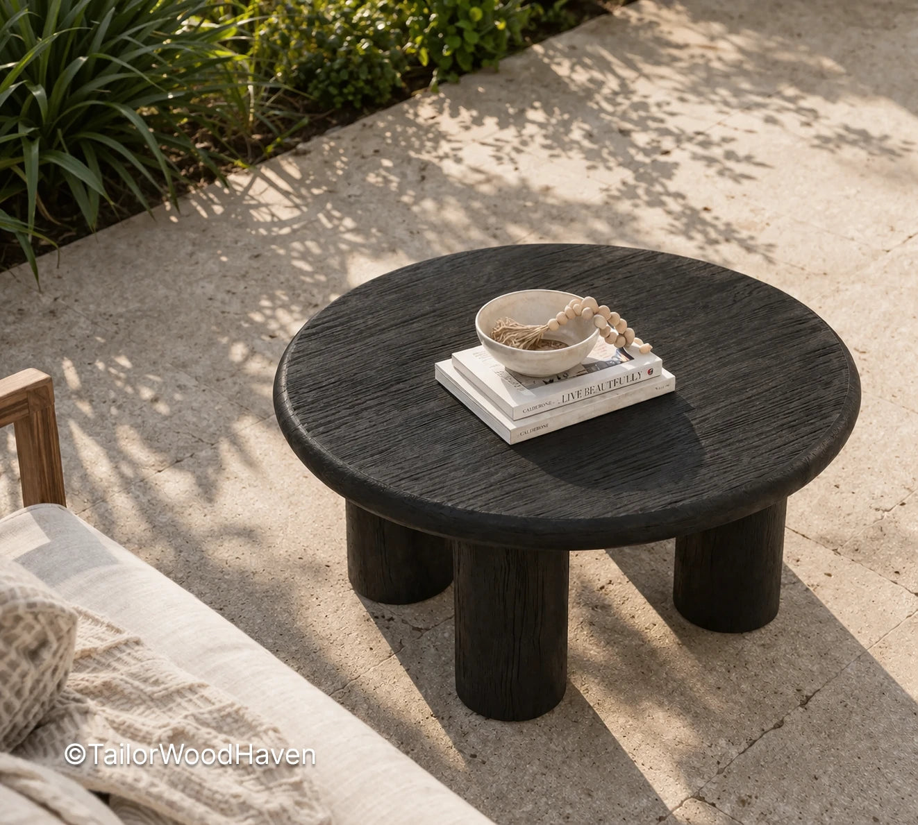 Minimal round black outdoor coffee table with sturdy construction and smooth tabletop