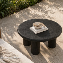Minimal round black outdoor coffee table with sturdy construction and smooth tabletop