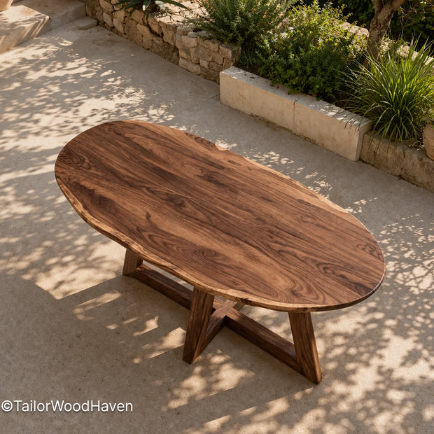 Oval outdoor coffee table made of solid wood with a smooth surface and balanced design