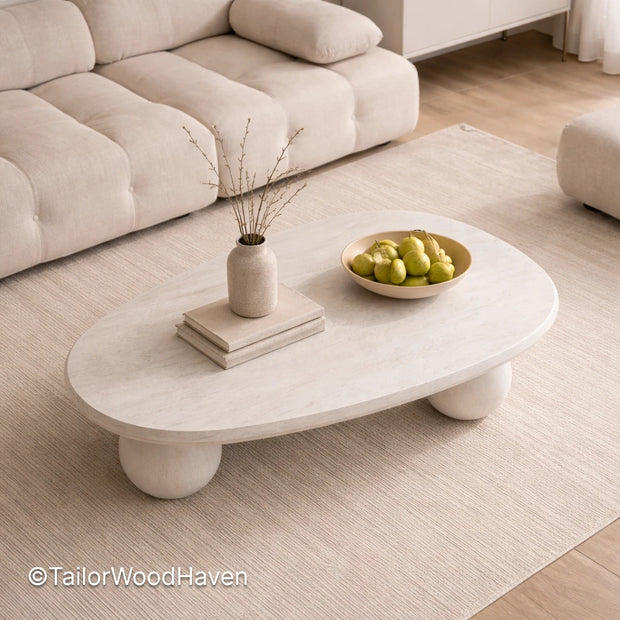 White oval coffee table in solid wood with smooth surface and minimalist design