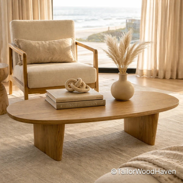Solid wood light oval coffee table with natural finish and clean edges