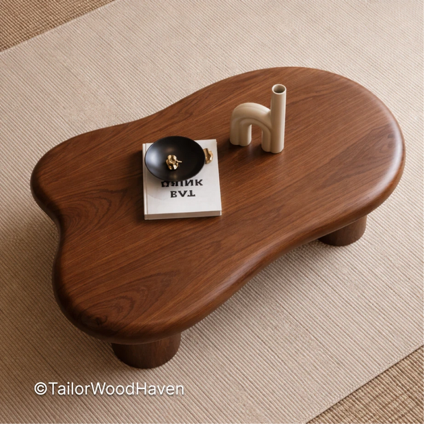 Small oval walnut coffee table with smooth top and minimalist design