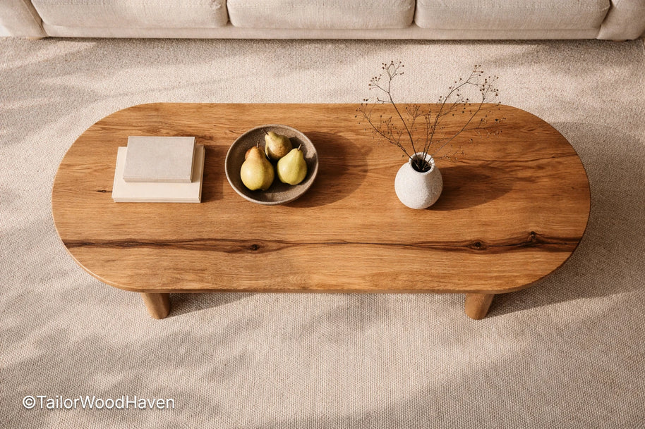 Solid wood oval coffee table with minimalist design and balanced proportions