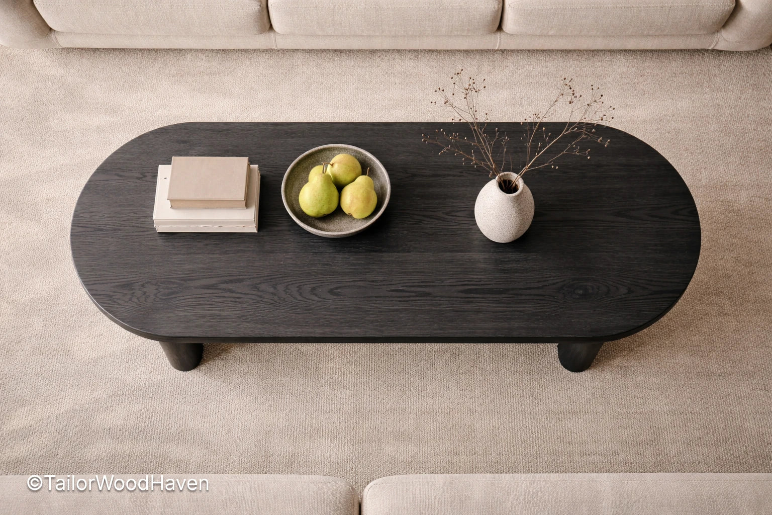 Dark wooden coffee table with decorative items on a beige carpet