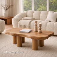 Small oval wooden coffee table in a living room with a beige sofa and decor items.