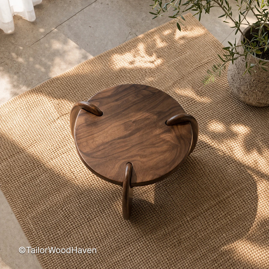 Small round solid wood coffee table with compact design and natural grain detail