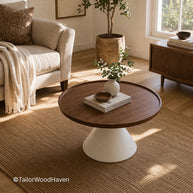 Huge round coffee table with wide surface and clean design in a spacious living room