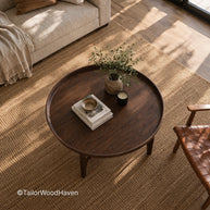 Round dark solid wood coffee table with clean edges and smooth finish
