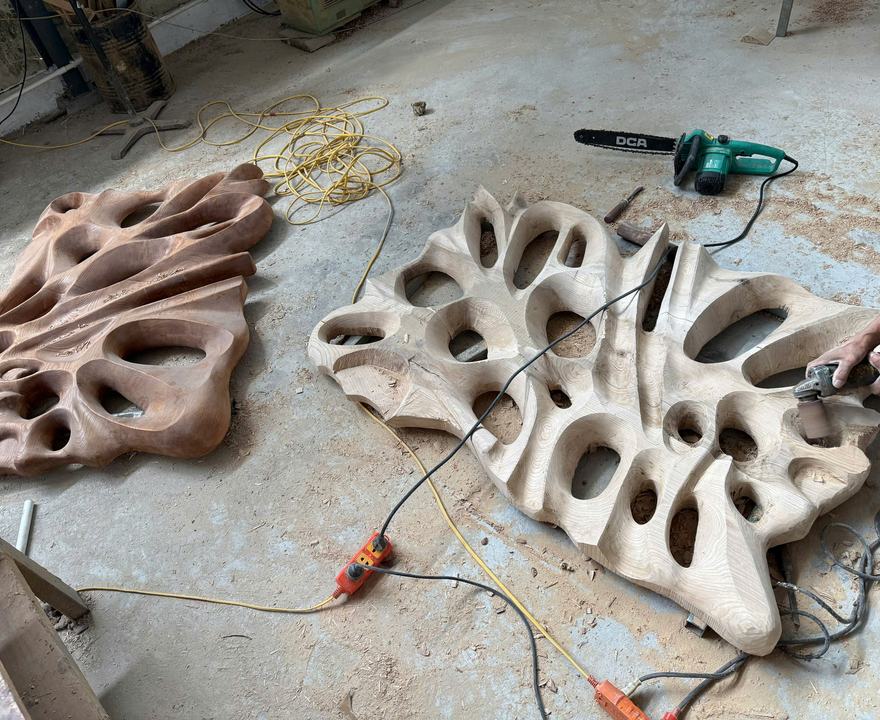 A carved wall panel being shaped by hand in our workshop