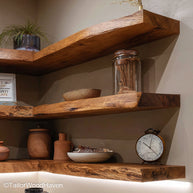 Natural wood floating corner shelf built with a soft live edge and right angle design, ideal for maximizing small corner spaces in earthy interiors