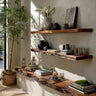 Live edge wood shelves designed with thick wood grain and freeform edge, wall-mounted to offer natural storage solutions in any living space