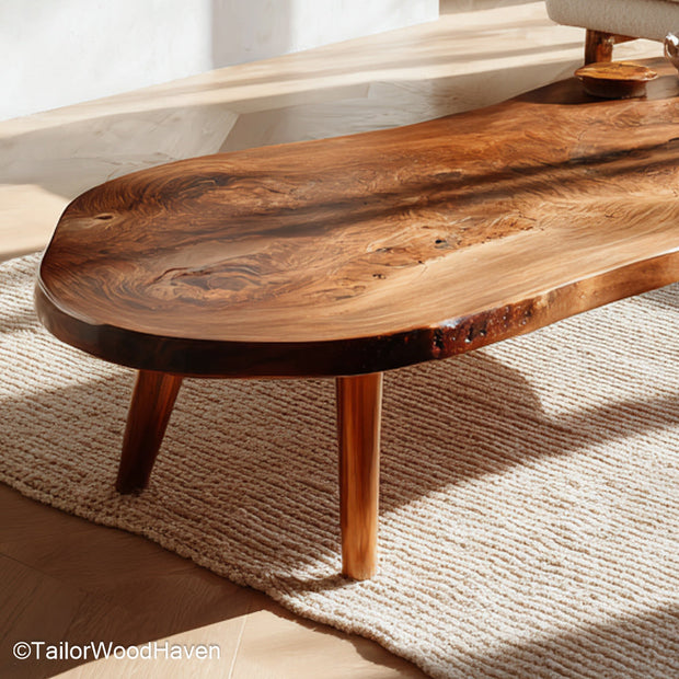 Raw cut wood coffee table built from real timber with a bold grain pattern and raw edge top, offering a centerpiece with rugged character